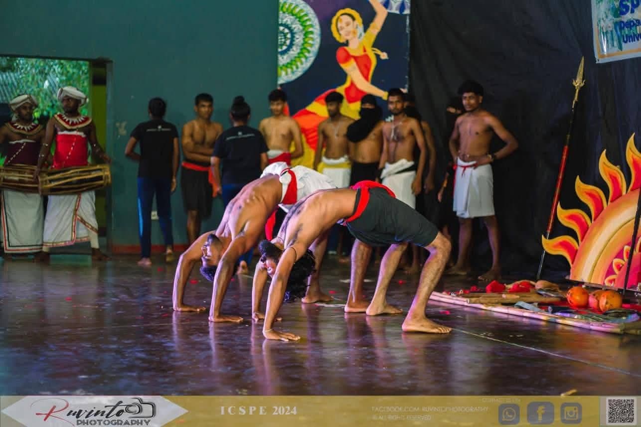 Angampora practitioners performing a live routine on stage